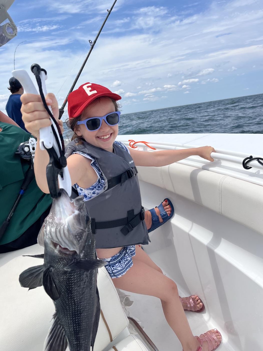 Young girl with a black sea bass